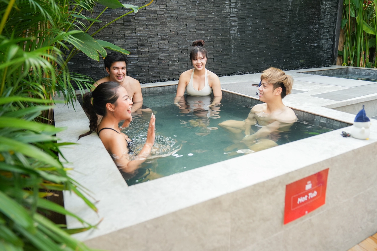 RizzUp Club members laughing in the hot tub